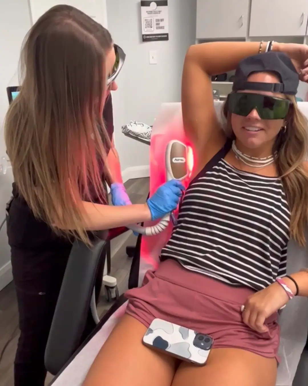 Licensed technician performing laser hair removal treatment on a female client’s leg at Optimal Health Family Practice Medspa in Provo, UT