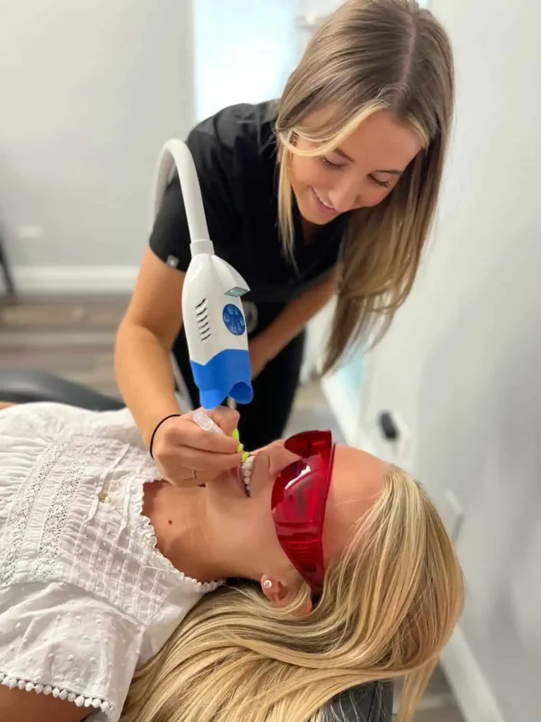 Client undergoing a professional teeth whitening treatment in Provo, Utah