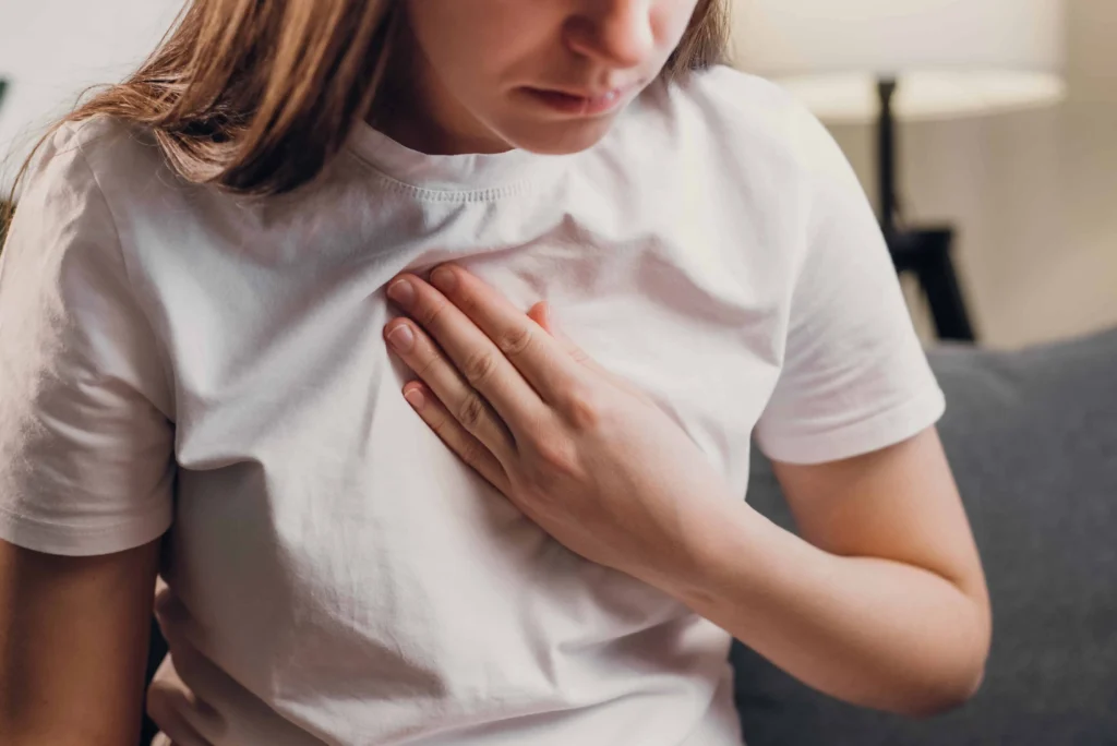 Woman with hand on chest seeking cardiometabolic disease treatment in Provo UT