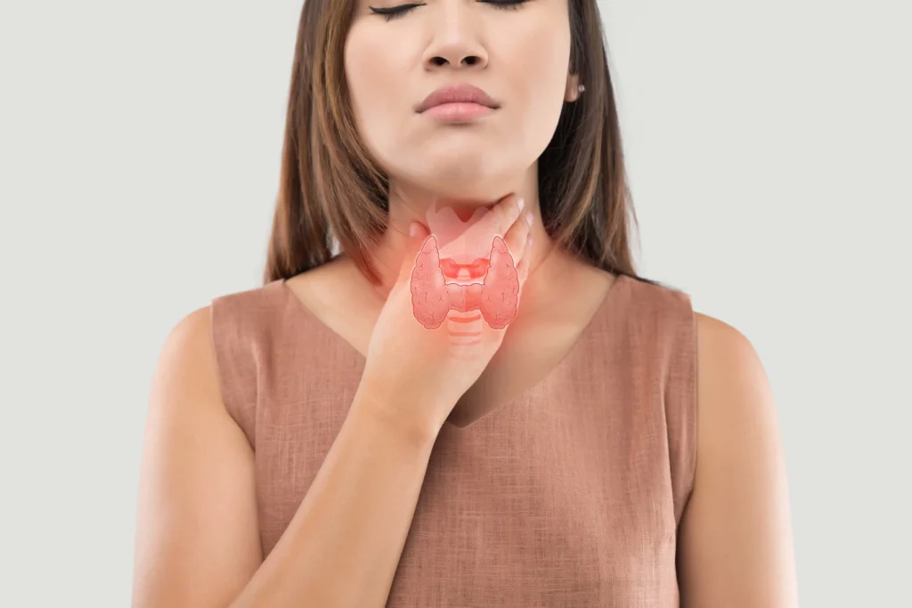 Woman showing thyroid gland location representing thyroid function and hormone health care