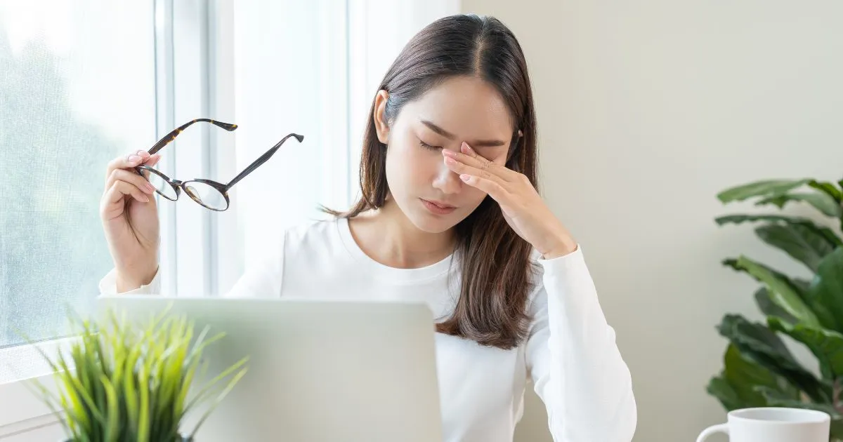 Woman experiencing eye strain and fatigue while working in Provo, UT